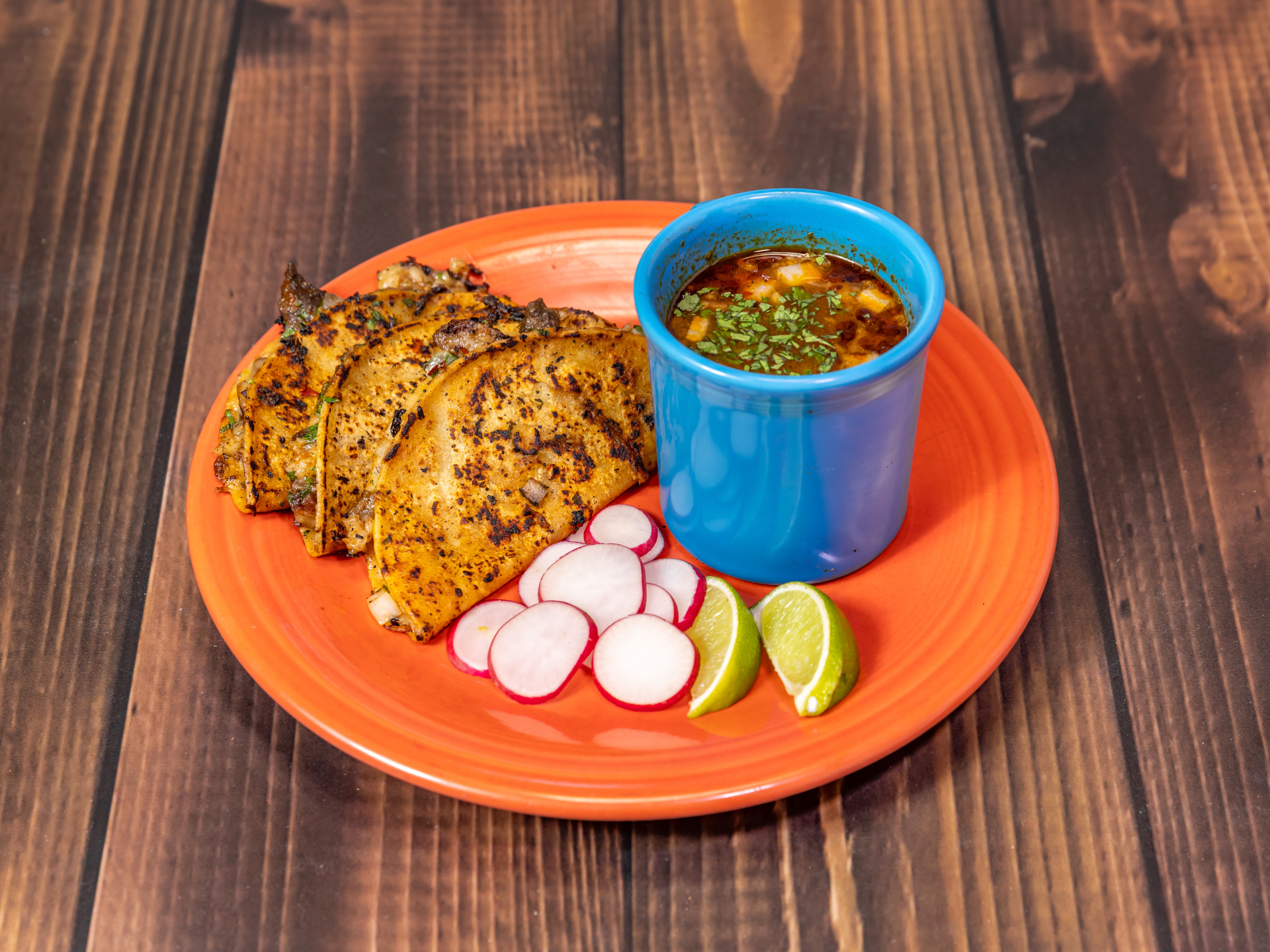 Birria de Res taco — Braised short rib, Oaxacan cheese, consommé