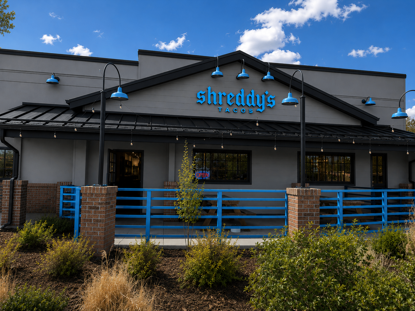 Shreddy's Tacos building exterior with bright blue signage