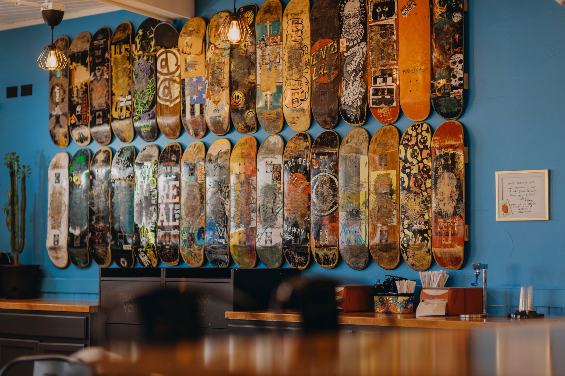 A wall of worn skateboards inside Shreddy's Tacos